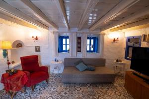 a living room with a couch and a tv at Authentic Bodrum House in Bodrum City