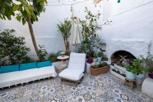 a patio with two white couches and a fireplace at Authentic Bodrum House in Bodrum City