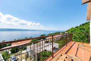 a balcony with a view of the water at Apartments Stipe in Lokva Rogoznica