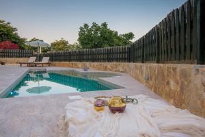 a swimming pool in a backyard with a fence at Golden Coast Boutique - Luxury Living in Kypseli