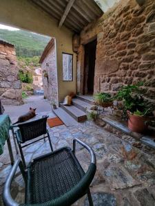 a cat laying on the floor of a stone building at Alojamiento Casa Carlota in Villadesuso