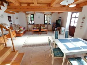 a living room with a table and chairs at 70 m2 Ferienwohnung Jurići in Steinhaus unweit von Poreč in Jurići