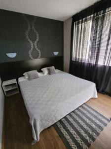 Postel nebo postele na pokoji v ubytování Guest House Taligarov