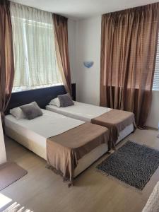 Postel nebo postele na pokoji v ubytování Guest House Taligarov