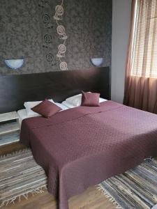 Postel nebo postele na pokoji v ubytování Guest House Taligarov