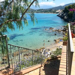 a view of a beach with people in the water at La casetta di Nonno Emilio a Palinuro in Palinuro