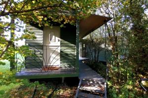 a house with a porch with a glass door at Penn Bergeyn Shepherd's Huts in Exeter