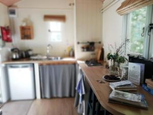 a kitchen with a wooden counter top in a room at Penn Bergeyn Shepherd's Huts in Exeter +26 photos