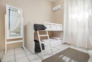 a small room with two bunk beds and a mirror at Casa di Zou in Skala Marion