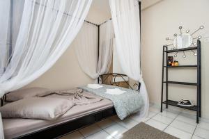 a bedroom with a bed with white curtains at Casa di Zou in Skala Marion