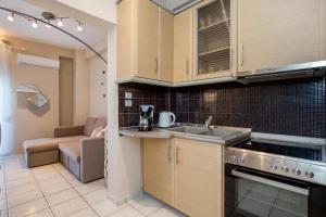 a kitchen with a sink and a stove top oven at Casa di Zou in Skala Marion