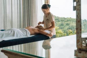 a woman giving a man a massage in a room at Malabar Hill in Weligama