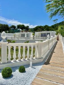a white fence in front of a building at Sirena Suite Deluxe in Peschici