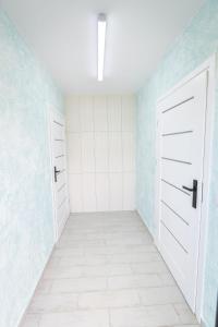 an empty room with two white doors and blue walls at KempingZator in Zator +132 photos