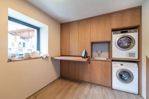 a laundry room with a washer and dryer and a window at Apartments Am Platzl Living in Laion