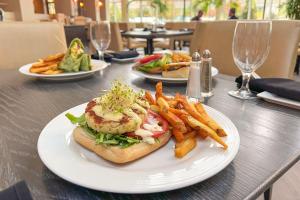 a table with plates of food and french fries at Marriott Jacksonville Downtown in Jacksonville