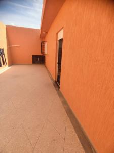 an empty hallway of a building with an orange wall at اسفي سعيدة 2 in Safi