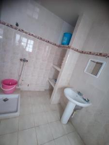 a white bathroom with a sink and a toilet at اسفي سعيدة 2 in Safi
