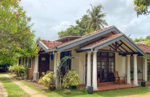 a small house with a porch and a patio at Agasthi Airport Close in Katunayaka