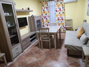 a living room with a table and a couch at Apartamento MG in Ayamonte