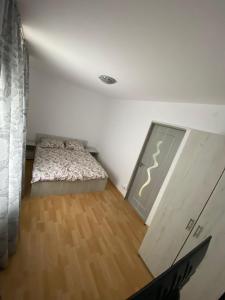 a small bedroom with a bed and a closet at Apartament in Mangalia in Mangalia