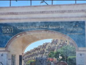 شاليه عائلات هواة الهدوء -مارسيليا علم الروم- بدون شاطي خاص في مرسى مطروح: لوحة لمنشأة سكنية على جانب مبنى