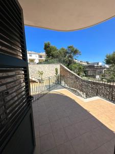 a balcony with a fence and a walkway at RESIDENCE IL GIARDINO DI DONNA LEDA in Castro di Lecce