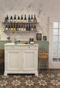 a room with shelves of wine bottles on a wall at LA CASA DINA in Banyuls-sur-Mer +83 photos