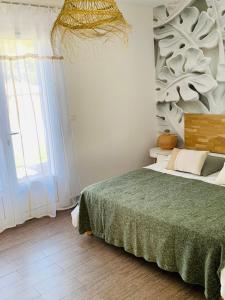 a bedroom with a bed and a large window at Casa Eva Maria in Patrimonio