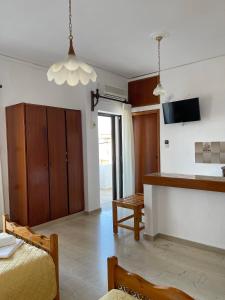 a living room with a bed and a kitchen at Aeolos Apartments Kolymbari in Kolymvari