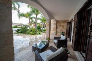 an outdoor patio with chairs and a table and a pool at Villa Silvana in Lecce
