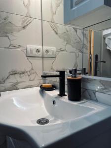 a bathroom with a white sink and a mirror at Runolist Chalet in Žabljak +153 photos