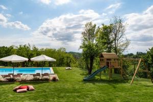 a backyard with a pool and a playground with a slide at Casa San Grato in Monteu Roero