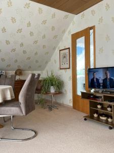 a living room with a flat screen tv on a table at Ferienwohnung Paulina in Braunschweig