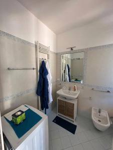 a bathroom with a sink and a toilet and a mirror at RESIDENCE IL GIARDINO DI DONNA LEDA in Castro di Lecce