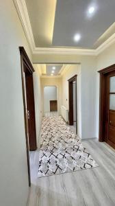 a hallway of a house with a tile floor at KUDÜS APART in Bostancı