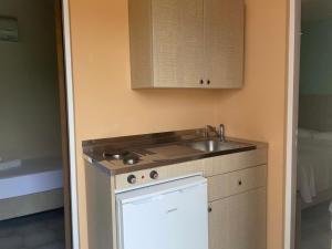 a small kitchen with a sink and a dishwasher at Andreas Studios in Svoronata