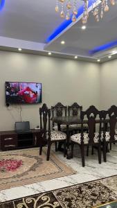 een eetkamer met stoelen en een tafel en een tv bij شقه للايجار بمدينه نصر in Caïro