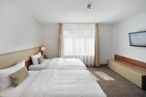 Postel nebo postele na pokoji v ubytování Downtown Vi Vadi Hotel