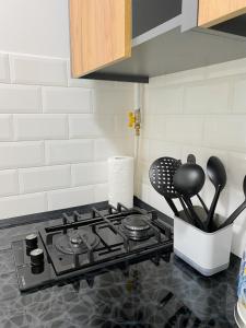 a kitchen counter with a stove top with utensils at Urban Home in Kyiv