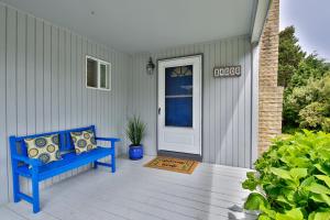a blue bench sitting on the porch of a house at Sandpiper Shores in Florence