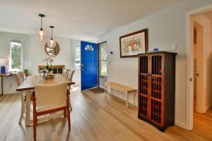 a dining room with a table and a blue door at Sandpiper Shores in Florence