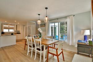 a kitchen and dining room with a wooden table and chairs at Sandpiper Shores in Florence