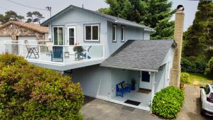 a blue house with a balcony and a porch at Sandpiper Shores in Florence