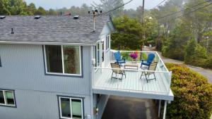 a porch with chairs and a table on a house at Sandpiper Shores in Florence