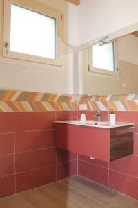 a bathroom with a sink and a mirror at Corte del Sole in Valeggio sul Mincio