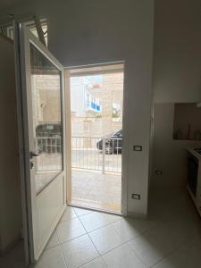 an empty room with an open door to a patio at White House in Torre Canne