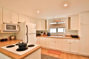 a kitchen with white cabinets and a white refrigerator at Sandpiper Shores in Florence