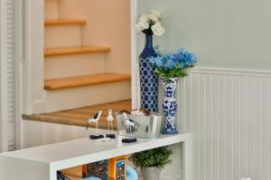 a white shelf with flowers and vases on it at Sandpiper Shores in Florence