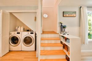 a laundry room with a washer and a staircase at Sandpiper Shores in Florence